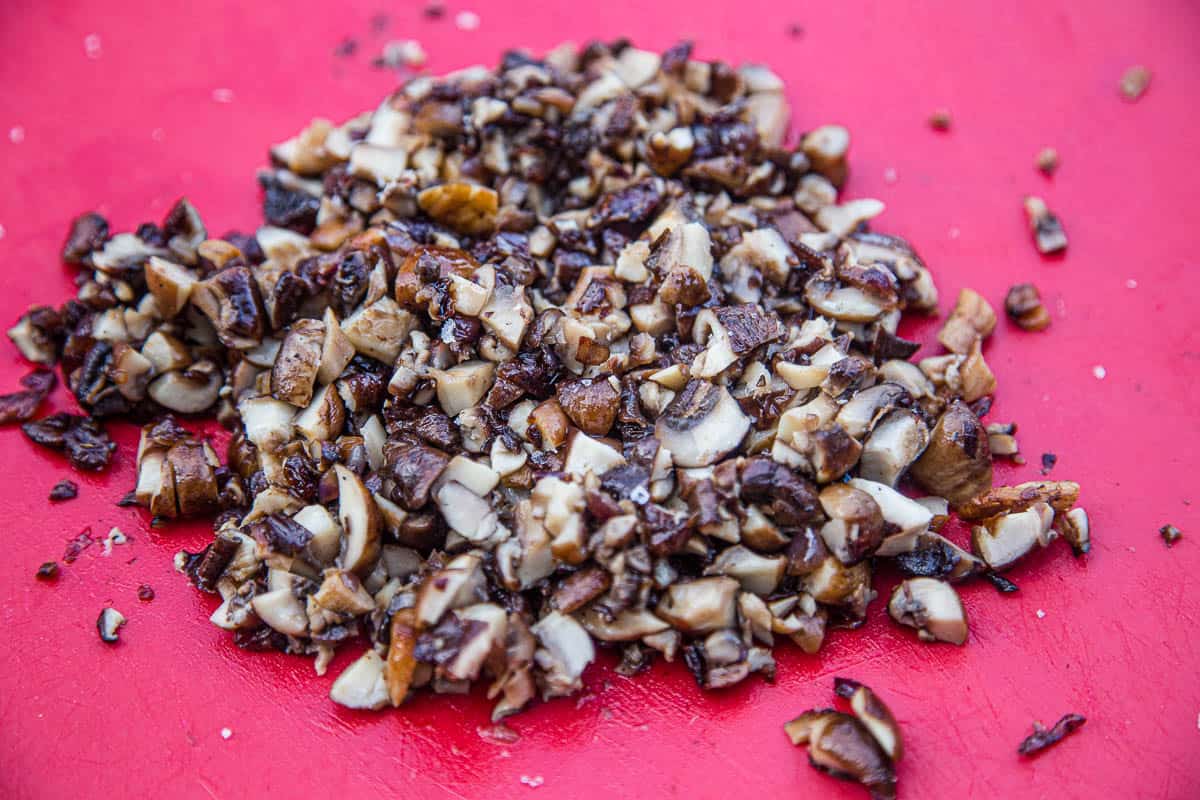 Chopped grilled mushrooms on a cutting board