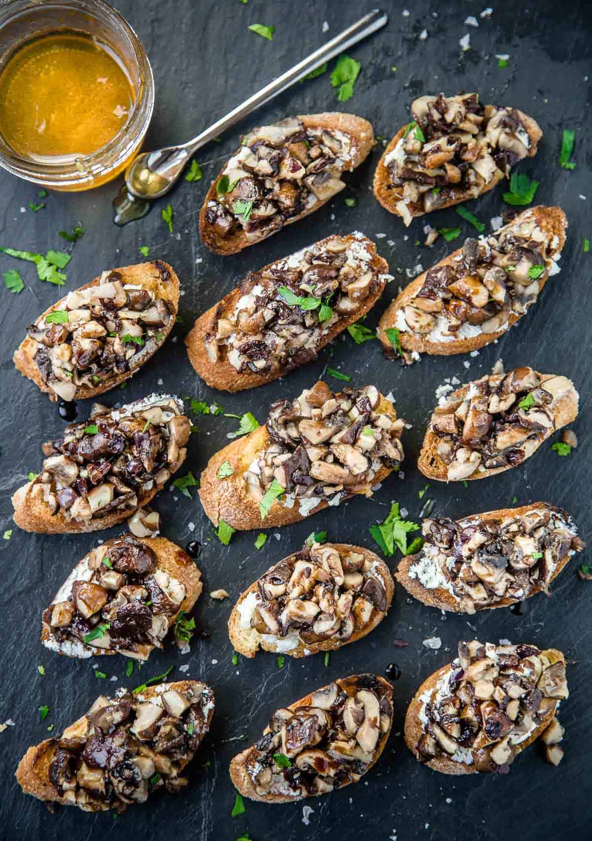 Grilled Mushroom Crostini on a platter with honey and aged balsamic