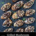 Grilled mushroom crostini on a slate plate.