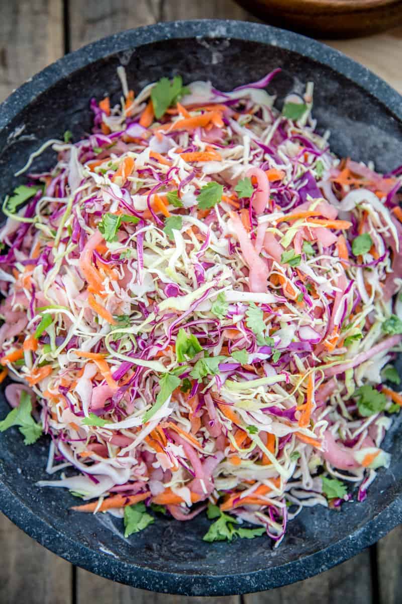 Smoked Pickled Onion No Mayo Coleslaw in a large black bowl