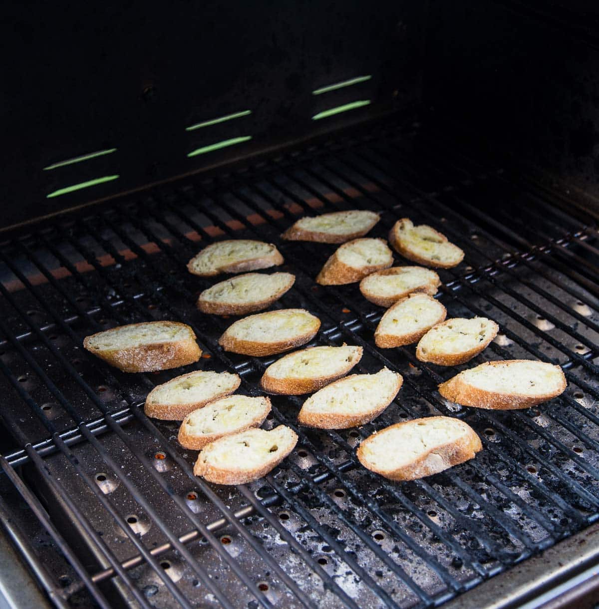 Toasting crostini on a grill