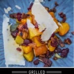 Grilled beets with bacon, parmesan cheese, cranberries, and dressing on a blue plate.