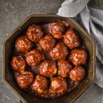 Cheese Stuffed Smoked Meatballs with BBQ Glaze in a FINEX cast iron pan