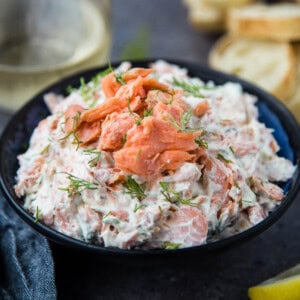 The best Smoked Salmon Dip in a serving bowl with a glass of wine