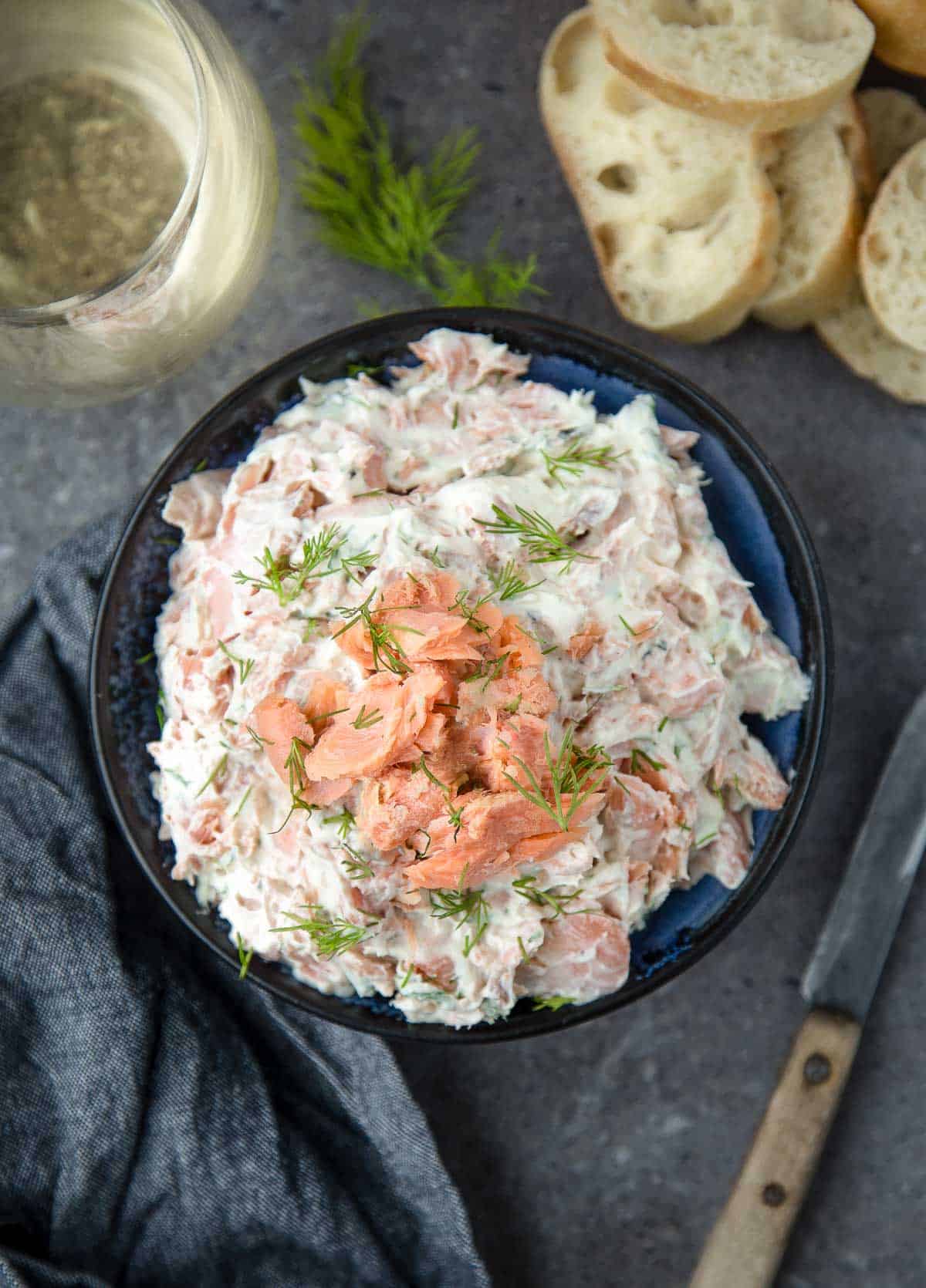 Smoked Salmon Dip in a bowl paired with a glass of white wine