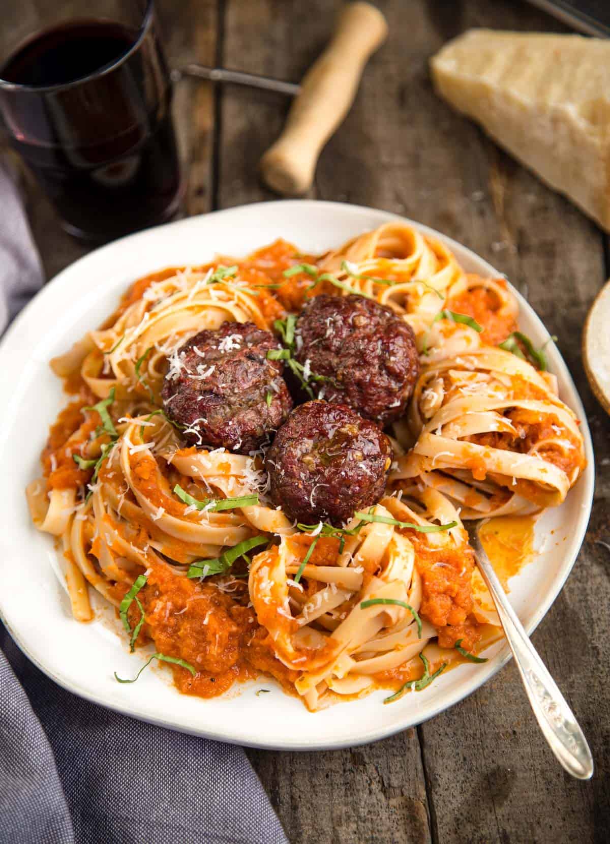 A bowl of smoke roasted tomato sauce with pasta and meatballs
