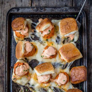 Buffalo chicken meatball sliders on a sheet pan.