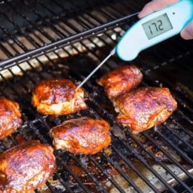 Temperature being taken of chicken thighs with Thermapen.