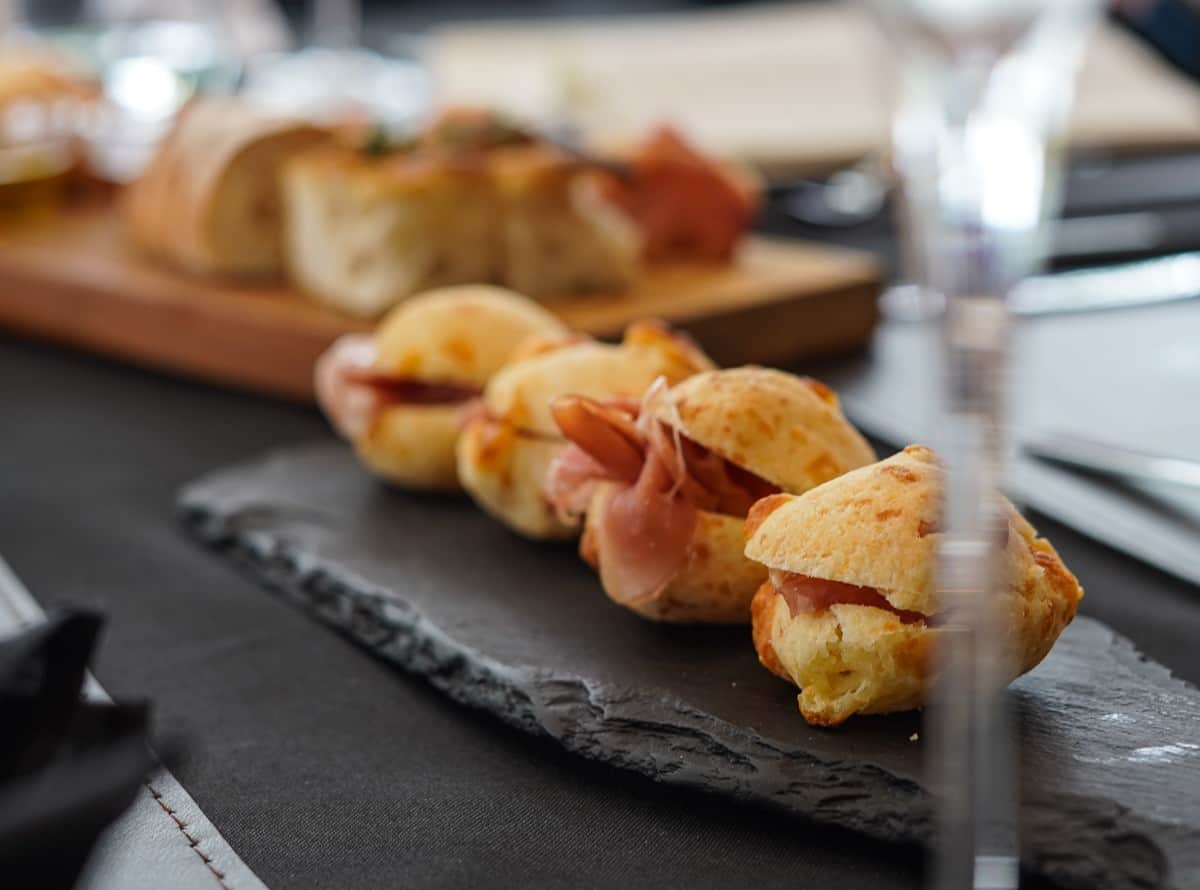 Pao de queijo served at Brazilian winery with prosciutto.