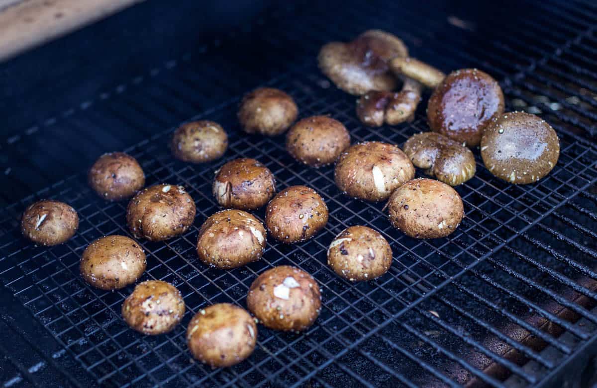 Mushrooms cooking on a smoker