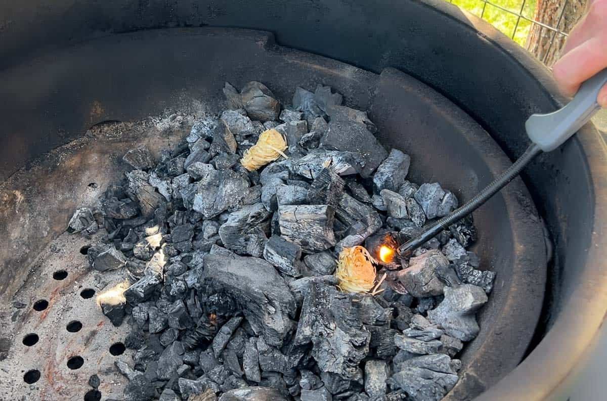 Fire starters igniting to start charcoal in a big green egg.