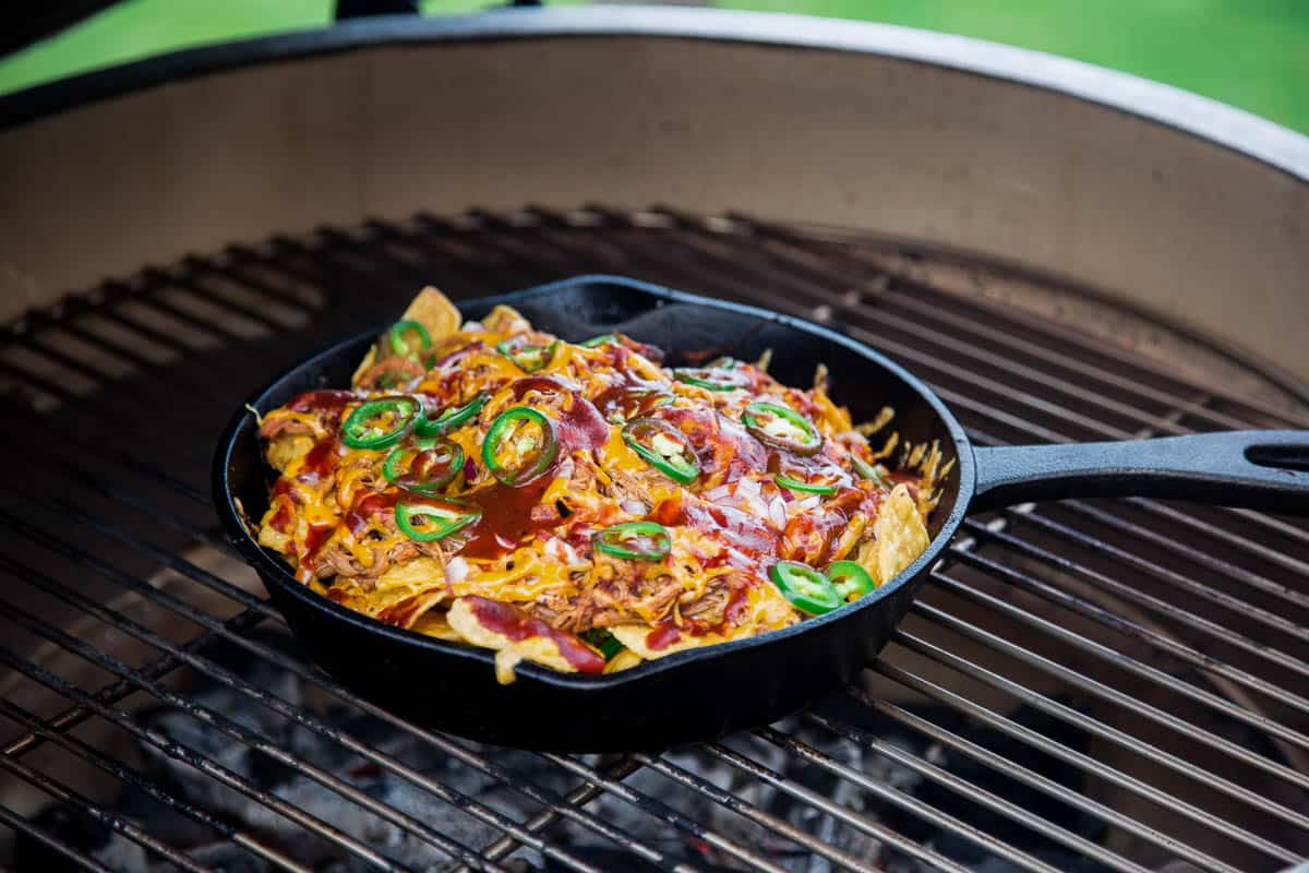 Pulled pork nachos being cooked on the Big Green Egg over direct heat.
