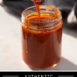 A pinterest pin with a mason jar of Buffalo wing sauce with a dripping spoon.