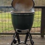 A large Big Green Egg with the top lid open.