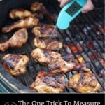 A thermometer measuring the temperature of chicken thighs on a grill.