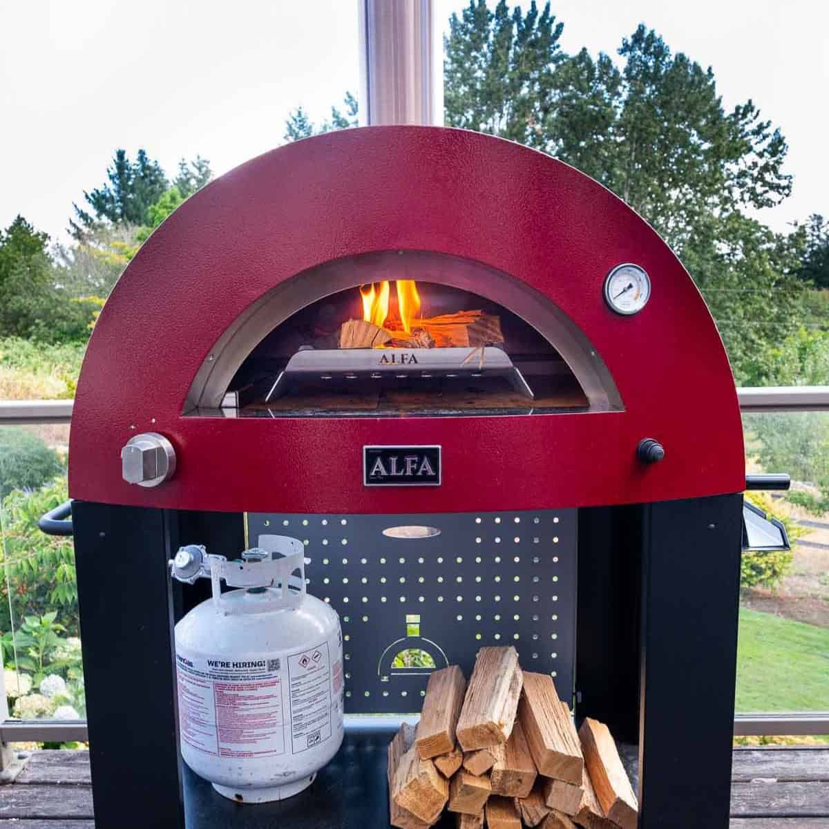 Square image of an Alfa Forni Pizze 2 Pizza oven with wood fire.