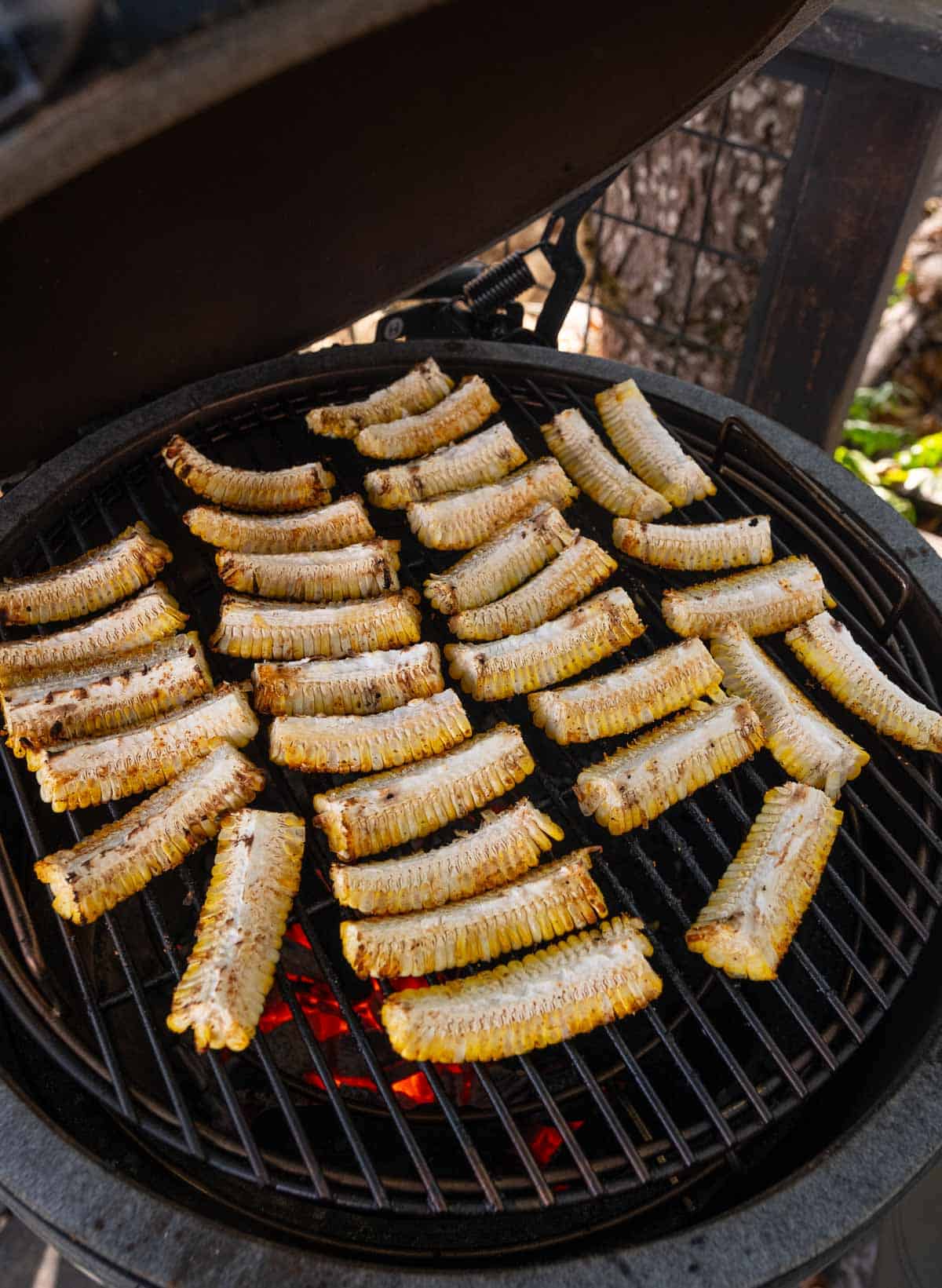 Grilling corn ribs on a charcoal grill.