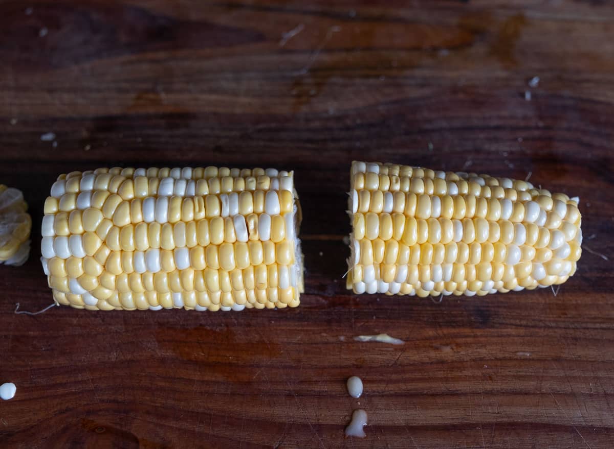 A trimmed corn cob cut in half lengthwise.