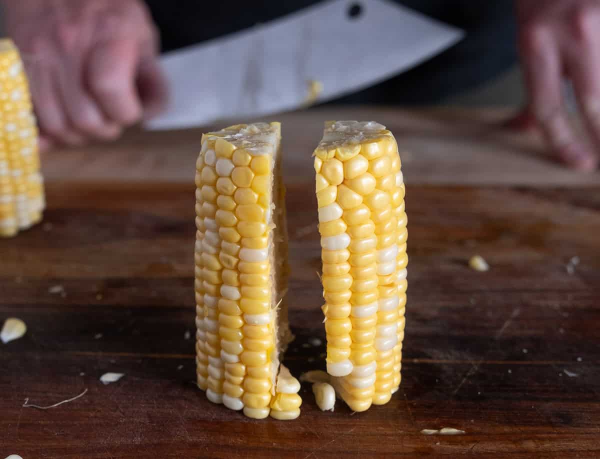 Cutting the halves of the corn halves again.