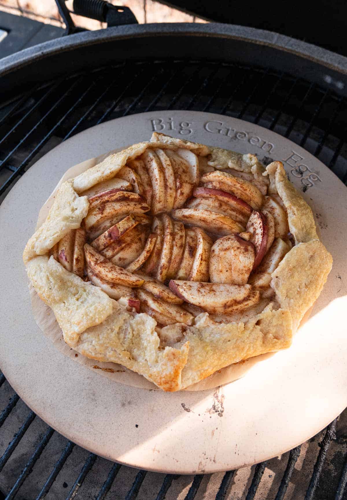 Apple Galette cooking on a big green egg grill over a pizza stone