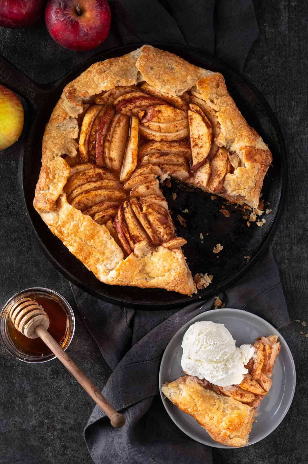 Grilled Apple Galette on a plate with a slice and a scoop of Ice Cream in a smaller plate