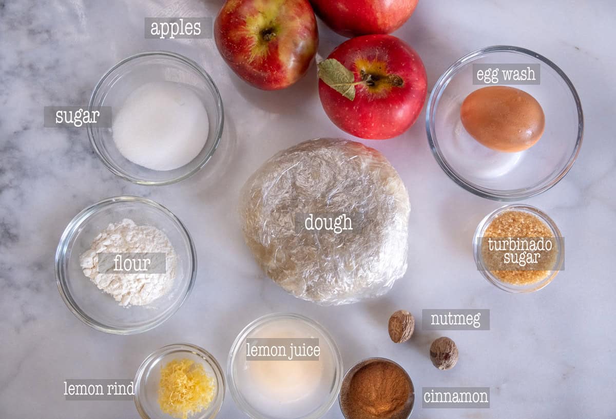 Ingredients on a marble slab for an apple galette recipe.