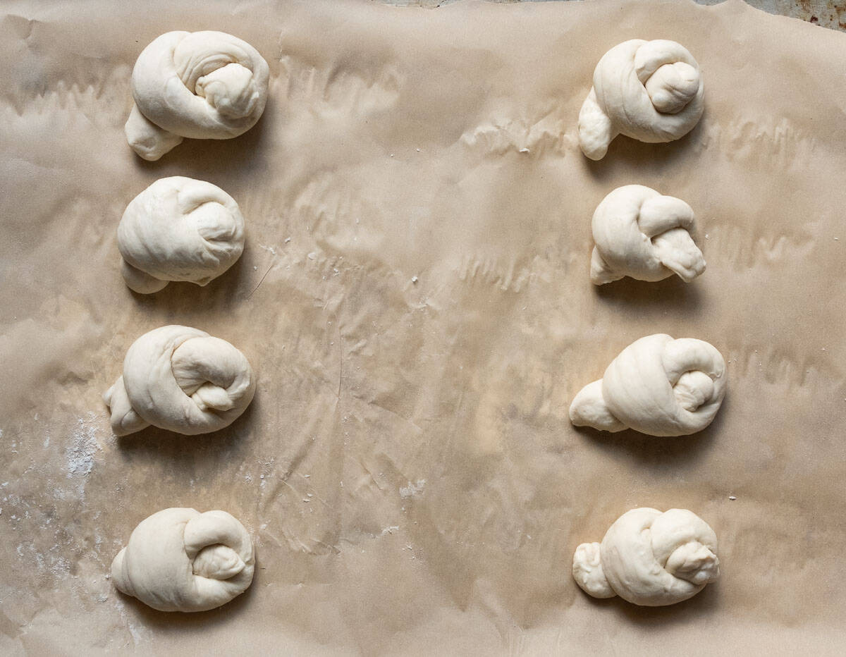 unbaked garlic knots on a baking sheet