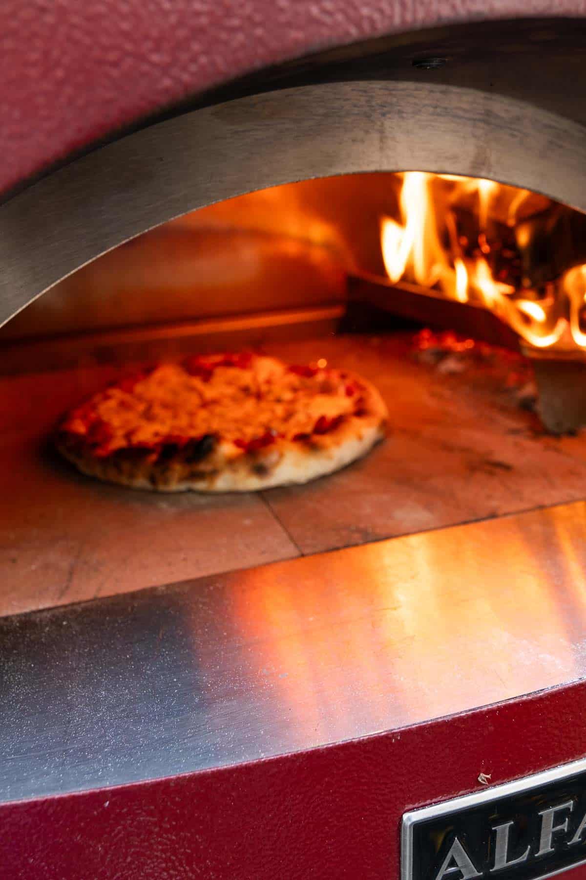 A turkey pizza in an Alfa Forni pizza oven.