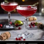 Pinterest pin showing two Christmas Mimosas in coupes on a table surrounded by garnish of cranberries and topped with fresh cranberries.