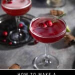 Pinterest pin showing two Christmas Mimosas in coupes on a table surrounded by garnish of cranberries and topped with fresh cranberries.