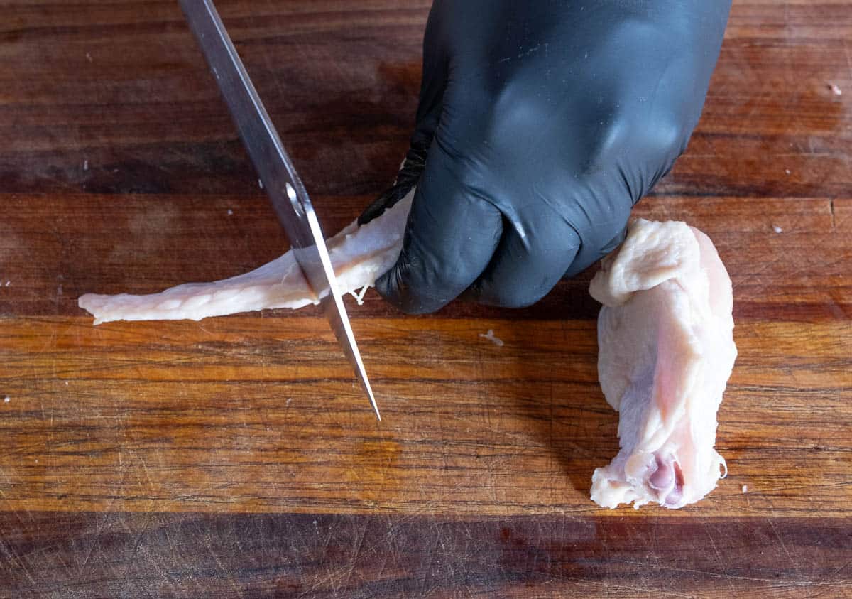 Separating the winglet from a whole chicken wing.