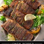 Pinterest Pin showing 4 grilled lemon pepper salmon steaks on a silver platter topped with lemon zest and lemon wedges.