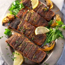 Grilled Lemon Pepper Salmon on a silver serving platter.