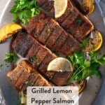 Pinterest Pin showing 4 grilled lemon pepper salmon steaks on a silver platter topped with lemon zest and lemon wedges.