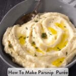 A pinterest pin with a side view of parsnip puree in a bowl topped with melted butter and thyme on a wooden table.