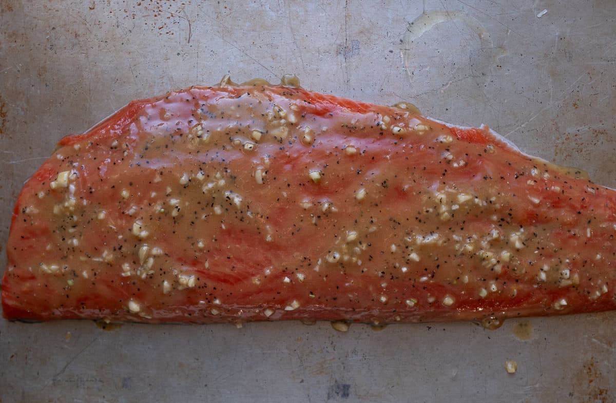 Raw salmon filet topped with a garlic lemon honey paste.