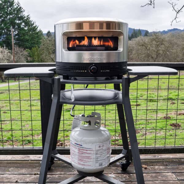 Solo Stove Pi Prime Pizza Oven on a backyard deck.