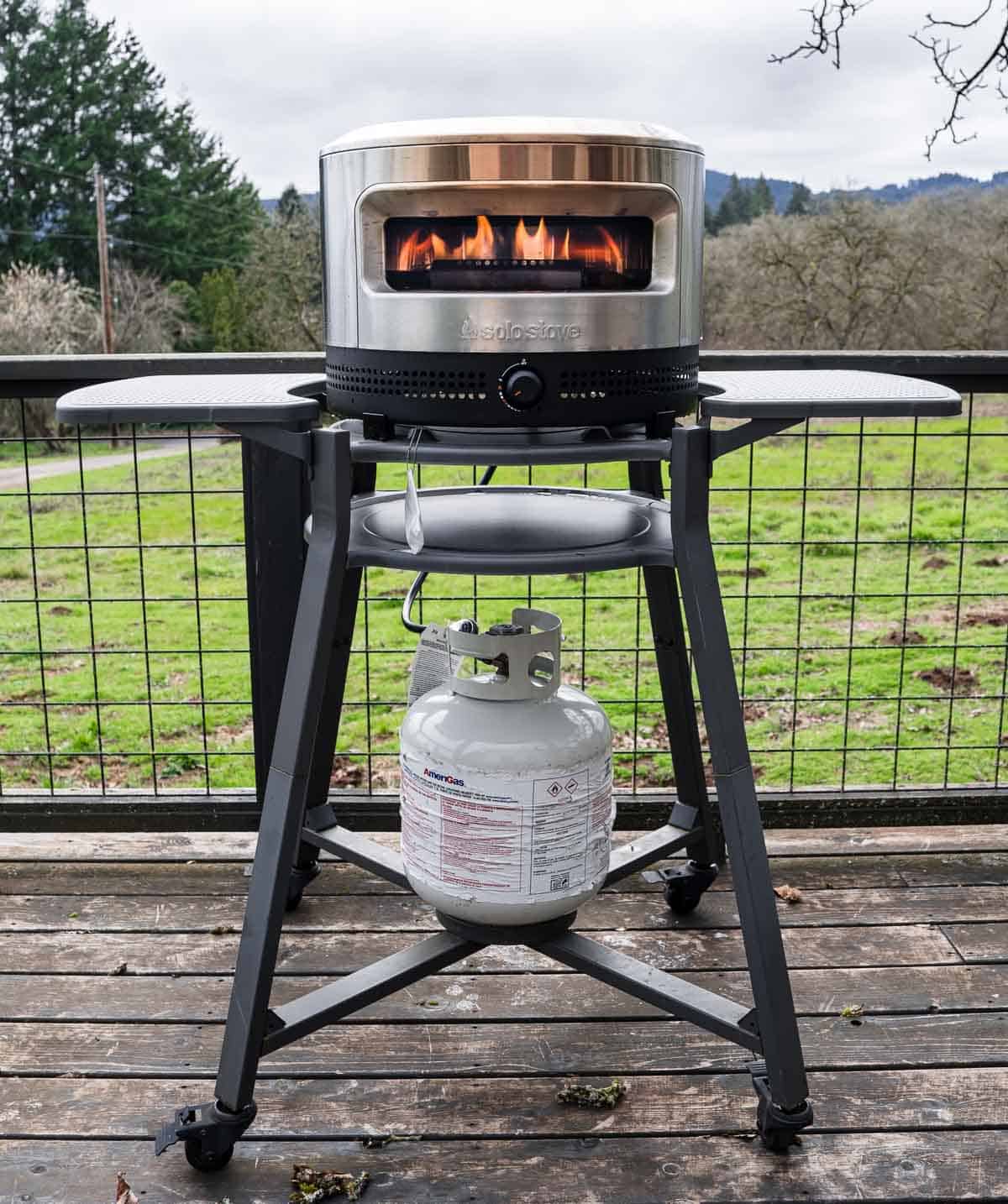 Solo Stove Pi Prime Pizza Oven on a backyard deck.